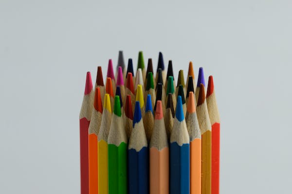 A cluster of coloured pencils standing upright. 